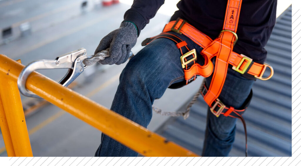 Construction worker use safety harness and safety line working on a new construction site project